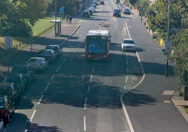 Bus straddles white line